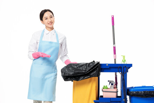 Female Cleaner Smiling at Blue Cleaning Cart with Supplies
