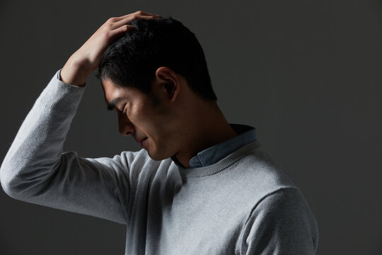 Sad man hand on forehead
