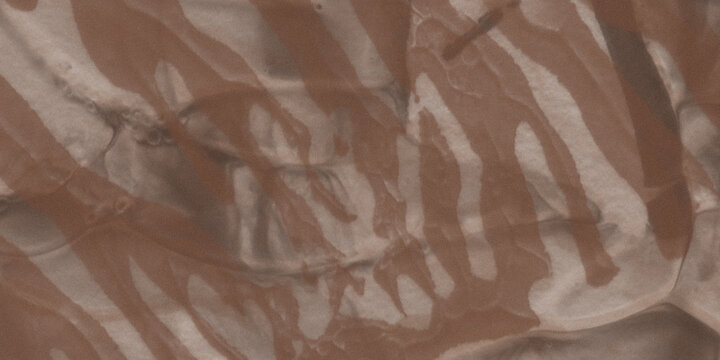 Abstract pattern of brown and white stripes resembling zebra print on a textured, slightly glossy