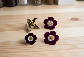 Obraz premium Botanical preservation and dried flowers, pressed purple blossoms and organic textures for natural decor and sustainable craft projects on wooden table