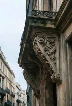 Urban architecture and heritage conservation, ornate stone balcony corbel on a historic building facade in a European city street with classic design