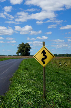 Winding Road Warning Sign Beside Rural Midwest Highway