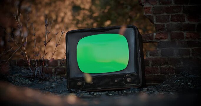 Vintage TV green screen with noise effect mockup in an abandoned post-apocalyptic ruin.
