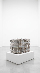 Fototapeta premium Compressed paper bale on white pedestal in gallery