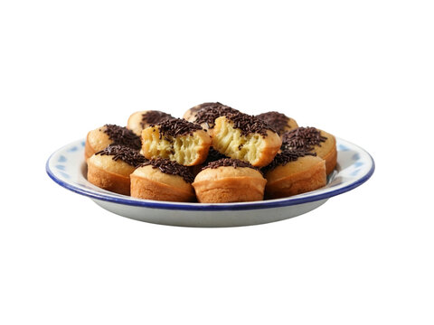 traditional indonesian mini sponge cakes kue cubit topped with chocolate sprinkles on patterned plate on white marble table