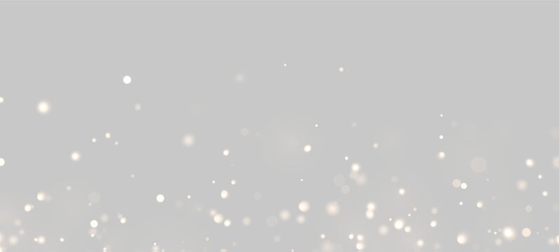Scattered soft golden light bokeh on black background. The glowing round particles vary in size and intensity. Perfect for festive or elegant decoration themes.