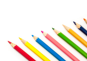 Fototapeta premium Colorful wooden pencils arranged diagonally on isolated white background with copy space.