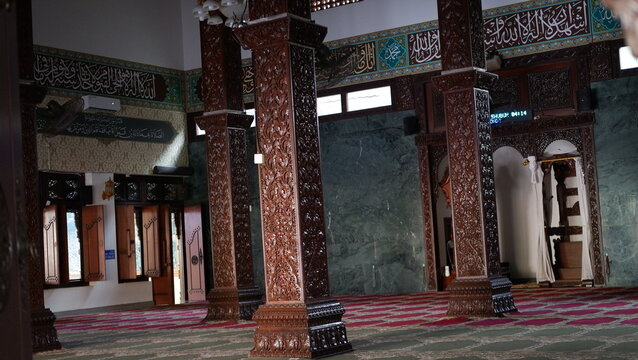 Intricate wooden carving on inside mosque gate showcasing cultural craftsmanship