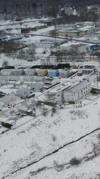 Aerial view of residential houses and snowy landscape in winter at Storas, Angered