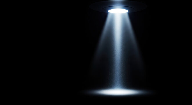 A bright spotlight shines from a circular ceiling fixture, projecting a powerful beam of light into a dark space.