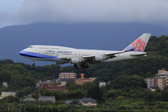 A China Airlines Boeing 747-400 on final approach above a hillside town (B-18215) on September 7, 2015 in Fukuoka, Japan.