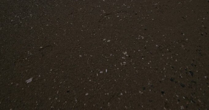 Cinematic tilt up gimbal shot of a long open Scottish beach