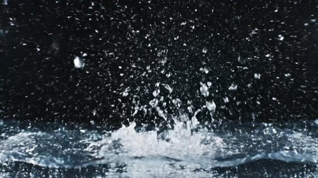 Dynamic water splash creating a crown shape and intricate droplets on black