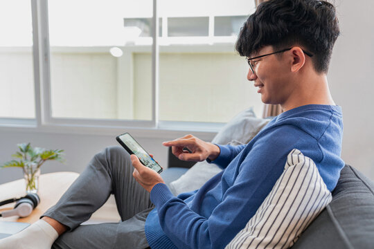 Asian man in casual clothes, using smartphone to working about b
