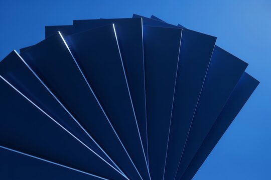 Fan of dark blue paper sheets with glowing edges on a vibrant blue background