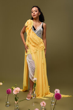 Stunning African American woman showcases elegance in a stylish outfit with flowers