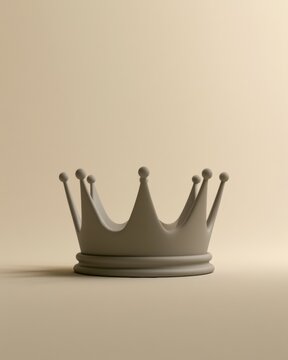 A simple matte crown rests on a softly colored surface. The setting has ample blank space for various projects or designs.