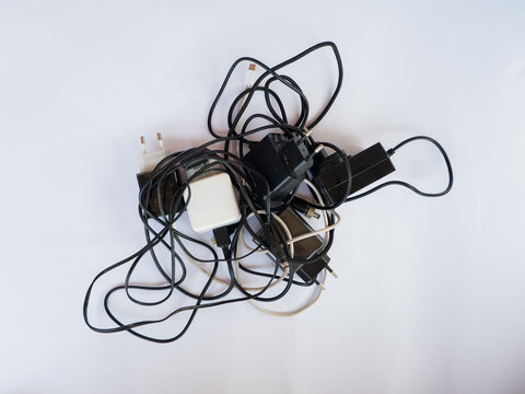 Tangled Cable Mess with Power Adapters and Chargers for Electronic Devices Concept