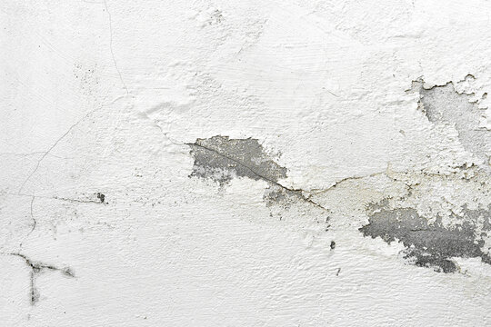 Peeling painted concrete wall. Leaking rain cause the wall and ceiling cracked.