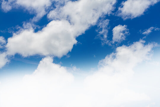 Beautiful blue sky with fluffy white cumulus clouds and abstract gradient white bottom border.