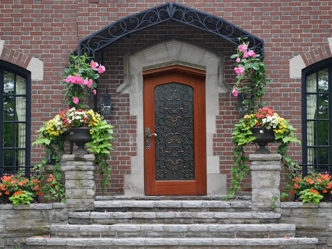Front door of house with flagstone steps and beautiful flowers