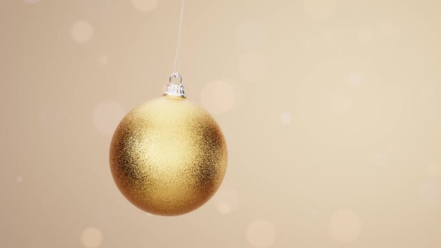 Golden Christmas bauble on elegant soft bokeh background loop