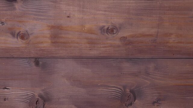 The planks are arranged horizontally, showcasing the fine markings characteristic of solid wood and creating a warm, rustic, and natural ambiance.
