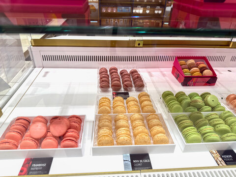 Fauchon macaron selection in luxury airport shop.