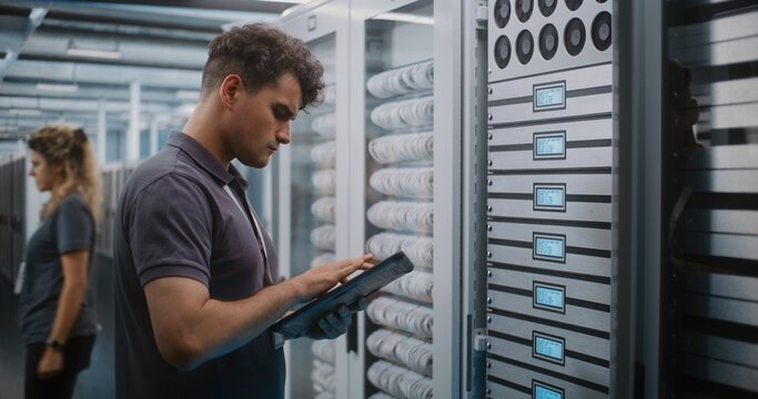IT Specialist Holds Digital Tablet and Uses Keys to Open Glass Server Cabinet Door Inspect Cooling Fans and Hardware Components. System Diagnostics, Physical Maintenance Ensure Optimal Server Airflow.