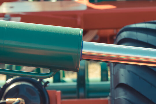 Green pistons or actuators in red pneumatic or hydraulic machine. Technology