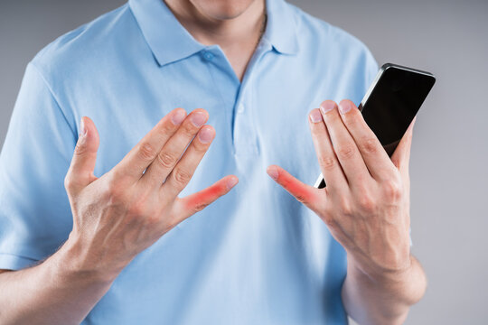Pain in little finger from holding mobile phone in your hand for too long. Smartphone syndrome, social media addiction and excessive screen time