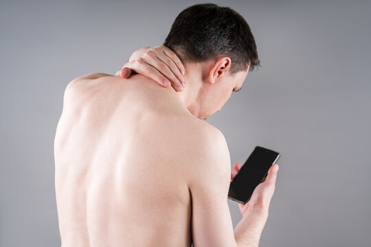 Neck pain due to smartphone use. Concept of poor posture, dependence on watching content and social media, insomnia