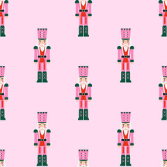 Obraz premium Seamless pattern of wooden nutcracker soldier toys on light pink background. Cute Christmas character backdrop suitable for festive wrapping paper holiday textiles and party decor.