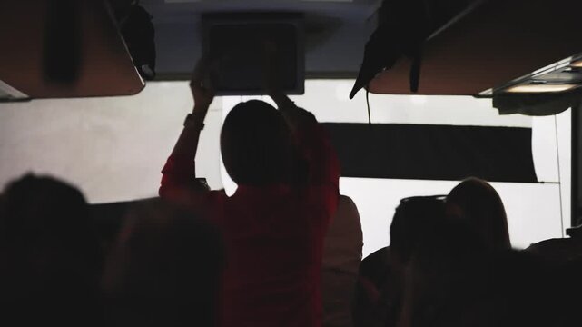 Traveler people having party dancing on trip in the bus in low light mode at night