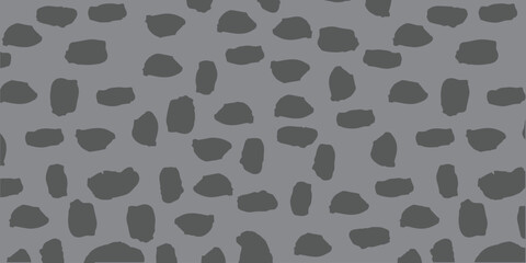 Naklejka premium Abstract seamless pattern with dark grey hand drawn brush strokes or pebble shapes on light grey background.