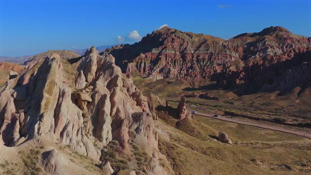 Aerial view of colorful Danxia landform, exotic rocky peaks in Zhangye, Gansu, China
Drone shot of magnificent alien‑valley rock formations, multicolored mountain landscape under blue sky