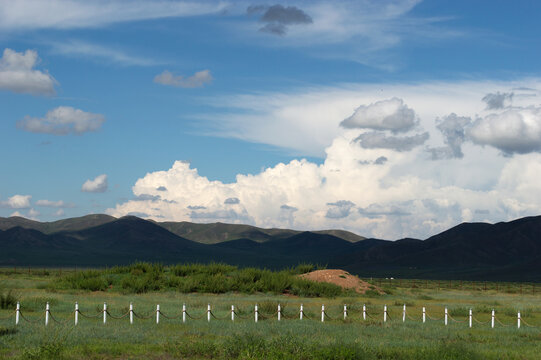 Fence line leading toward distant mountains, Tov Province, Mongolia