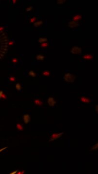 Abstract multicolor bokeh lights on a black background shift rapidly as blue, green, red and magenta glows appear, overlap and fade in quick succession, creating energetic motion.