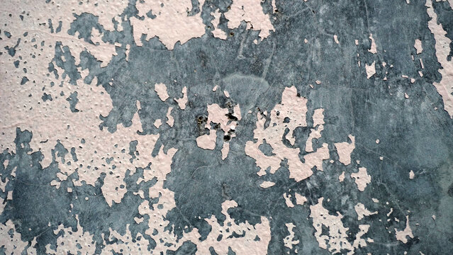 Distressed wall with cracked peeling paint revealing layered texture.