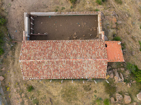 Top-down aerial view of a mountain livestock shelter and pen in Sierra de G&uacute;dar, Valdelinares, Teruel, Spain