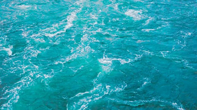 Churning Blue Ocean Water with White Foam and Wake Texture