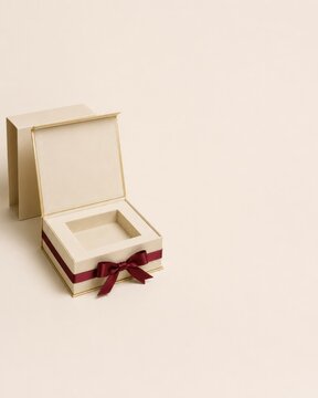 Open luxury beige gift box with custom insert and burgundy ribbon mockup on light background