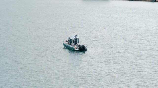 Rigid Inflatable Patrol Boat Cruising on Open Water Surface
