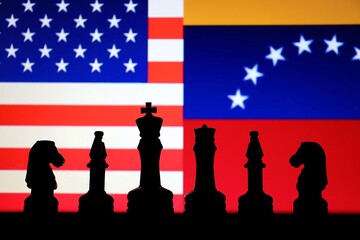 United States and Venezuela flags behind chess knight pieces. Oil negotiations, economic sanctions concept. © Blossom Stock Studio