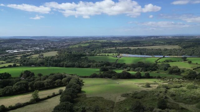 Hemerdon, West Devon, England: DRONE VIEWS: Newnham Estate Solar Farm, the River Tamar and Plymouth Sound. Solar panel farms are part of the UK government's renewables strategy for achieving net zero 