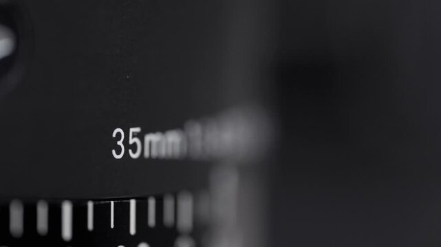 A close up of a ruler with the numbers on photographic camera lens