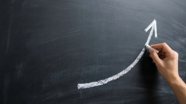 Hand drawing a white chalk arrow graph indicating upward growth on a dark blackboard