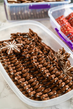Snowflake Gingerbread Cookie Among Rows of Festive Holiday Treats