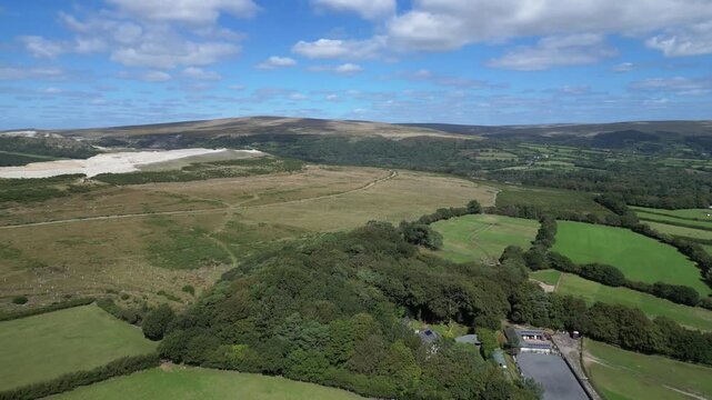 Hemerdon, Devon, England: DRONE VIEWS: Headon clay quarry & countryside; hill ranges of Dartmoor National Park in the distance. The Park covers 368 sq. miles and achieved national park status in 1951.