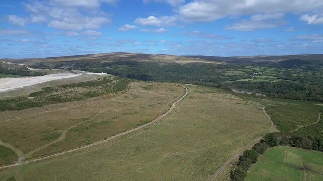 Hemerdon, Devon, England: DRONE VIEWS: Headon clay quarry & countryside; hill ranges of Dartmoor National Park in the distance. The Park covers 368 sq. miles and achieved national park status in 1951.